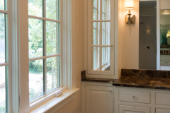 Raised panel, inset beaded in white with applied furniture skirt and mirrored top cabinet doors