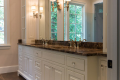 Raised panel, inset beaded in white with applied furniture skirt and mirrored top cabinet doors